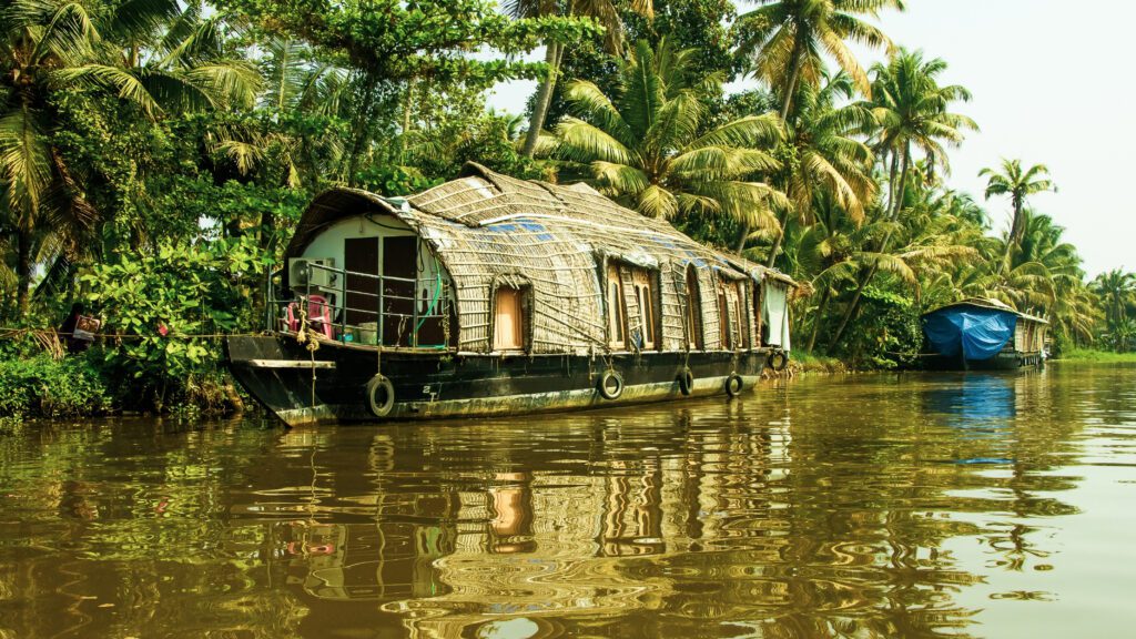 Traditional houseboat cruising through the serene backwaters of Alleppey, Kerala