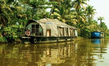 Traditional houseboat cruising through the serene backwaters of Alleppey, Kerala
