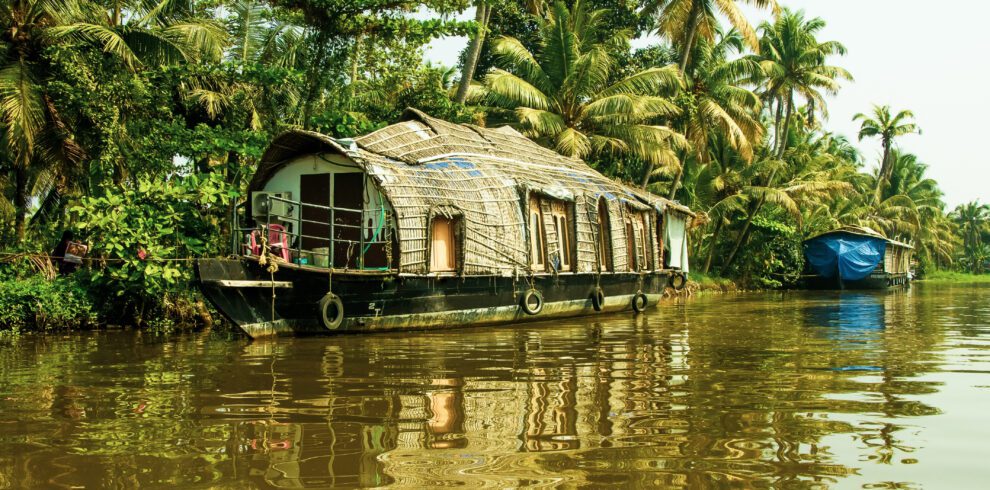 Traditional houseboat cruising through the serene backwaters of Alleppey, Kerala